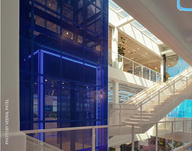 Steel elevator anchors headquarters in a century-old cotton mill retrofit