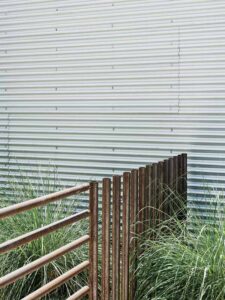 Construction debris found during site excavation is hidden inside the cages in lieu of going to a landfill.