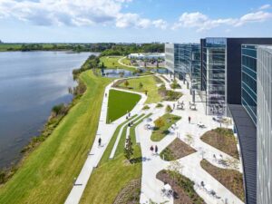 Located on Blue Heron Lake, the curve of the building frames the lake behind it. 