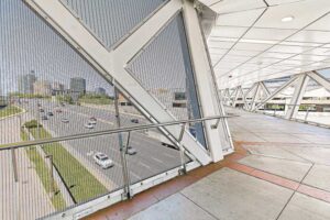 The design required the mesh to span the full length and height of the pedestrian bridge sections.