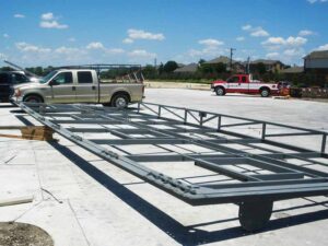 The all-steel tube frame lays flat on the site of the hangar, on it's way to be installed. 