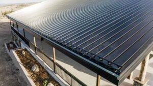 An aerial look at a metal roof on an office building, with a snow guard system installed on the edge. 