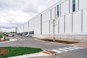 Exterior view of the warehouse featuring white metal panels. 