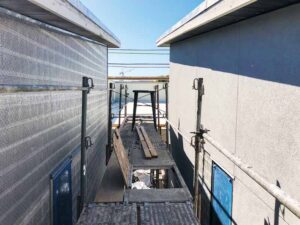 Two buildings with an alleyway in between illustrate the use of rainscreen materials. 