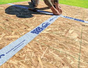 MFM brand tape is being applied to plywood. 