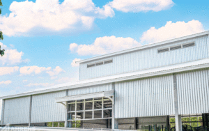 A close-up, diagonal look at the exterior of the steel structure and partial walls. 