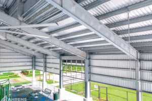 An up-close view of the underside of the metal roof and partial steel walls. 