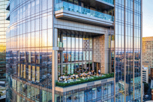A close-up view of people sitting on the outdoor patio on the 17th floor of the building.