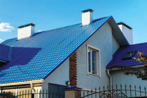 A close up view of a blue metal roof on a home. 