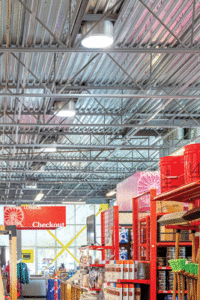 A narrow view of the open-concept ceiling and aisle filled with hardware supplies. 