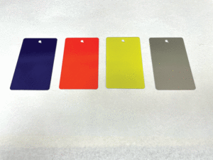 Four swatches of peelable coating color options lay side by side: purple, orange, yellow, and grey. 