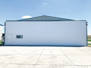 The now white airplane hangar door is shown to be new updated. 