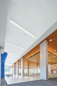 An up close, vertical view of an enclosed ceiling with potlights.