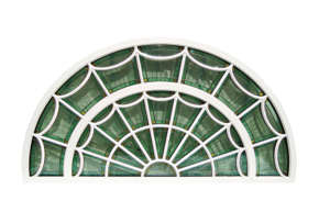 A white window frame is designed with an ornate, vintage appearance. 