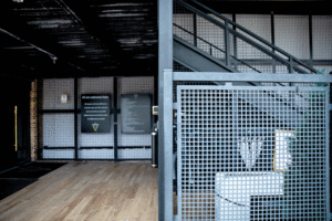 Metal mesh enclose areas near a stairwell. 