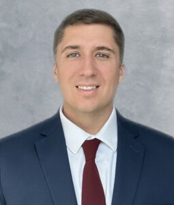 headshot of man wearing a suit