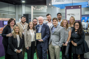 a group of people surrounding a person receiving an award