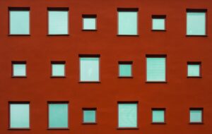 a red metal wall with windows