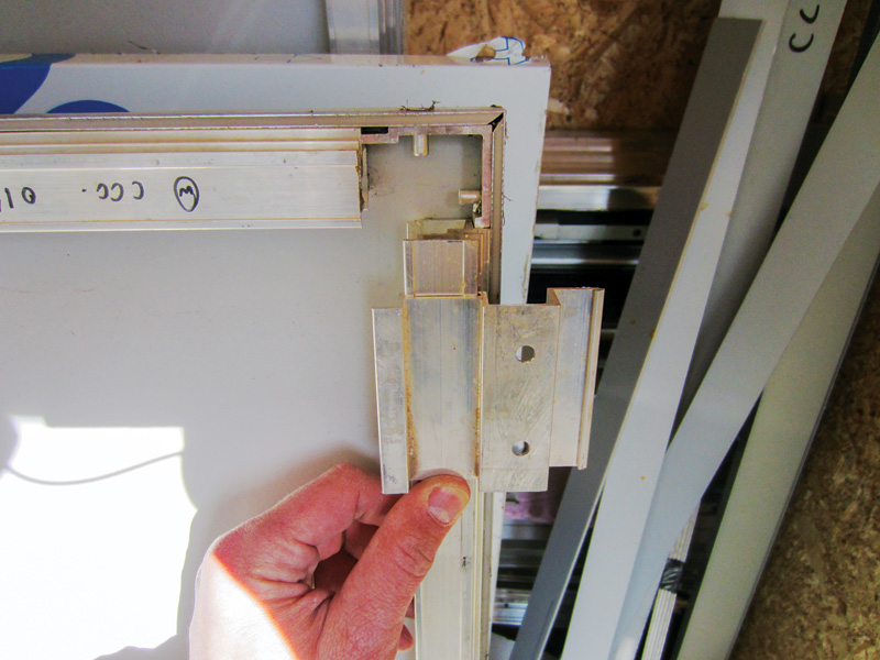 A zoomed in picture of a hand holding on to a small, structural clip.