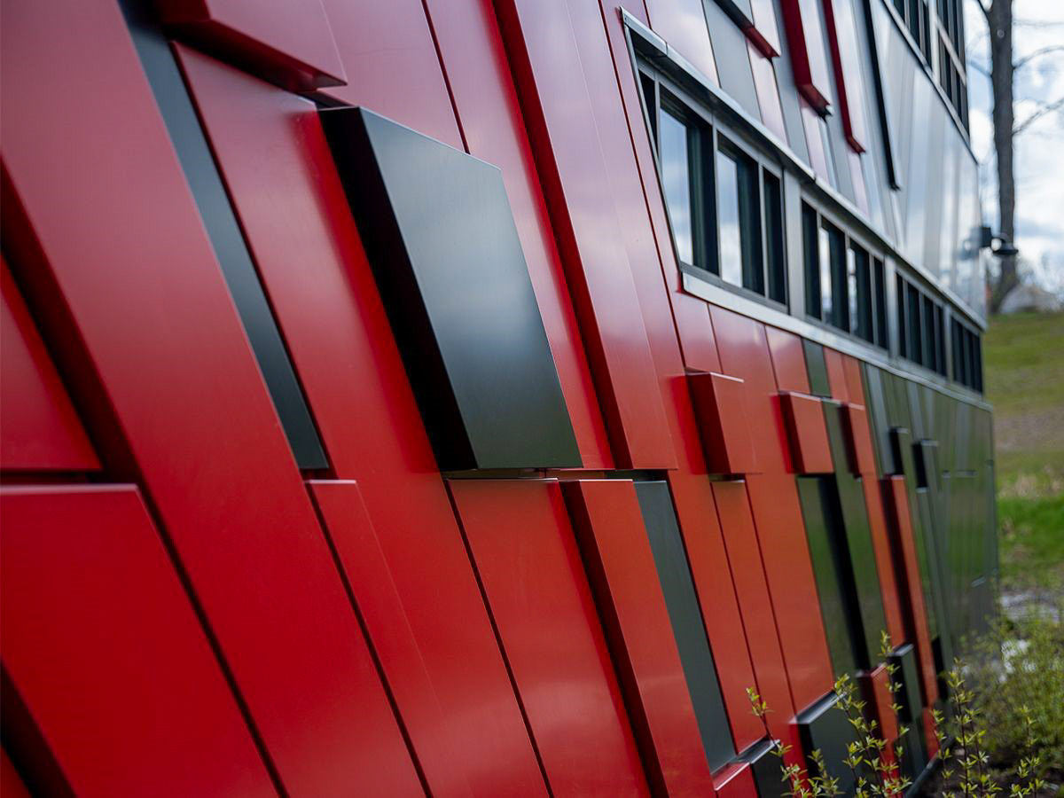 A close up of custom, 45-degree angled panels on the side of the building.