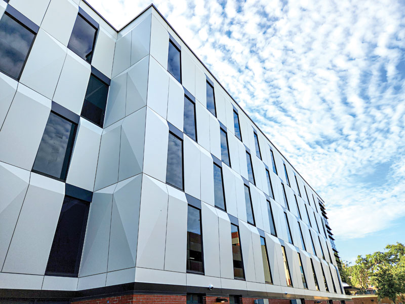 An academic building with alternating MCM panels and shaded window glazing.