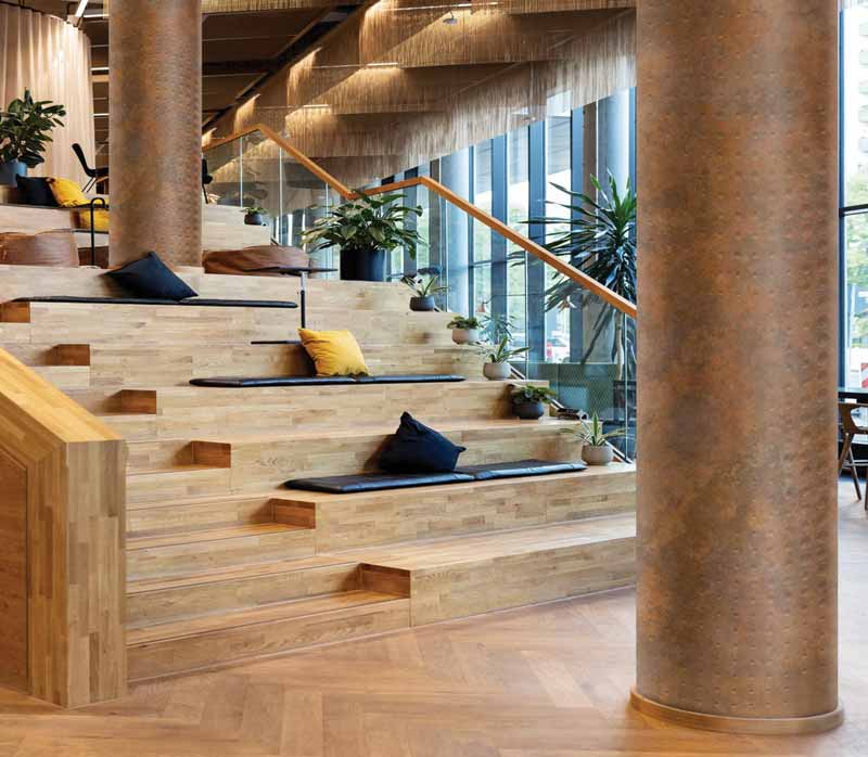 A round column stands in front of a wide, curving staircase. Behind it stands a similar column slightly up the staircase.