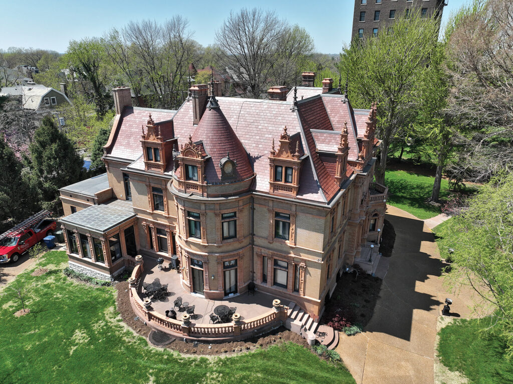 Aerial view of the historic Magic Chef Mansion in St. Louis with a restored copper roof, ornate detailing, and landscaped grounds.
