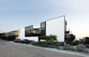 White building facade with metal railing in rooftop patio
