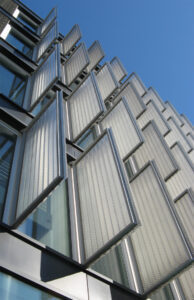 Expanded metal panels installed perpendicular to a building's exterior wall.