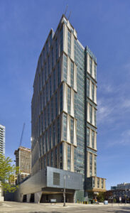Tall building side view with distinctive facade. Photographed during the daytime.