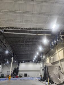 Display of rust-converting primer in industrial ceiling space.