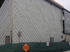 The photo illustrates a sealed, taped assembly with a diagonal application, photographed during the day.