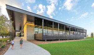 Exterior view of Texas A&M rec center with grass field visible.
