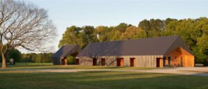 Exterior view of barn in vast, natural landscape.