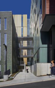 View of Catherine Commons pedestrian bridge, made of metal and visible from the building's exterior