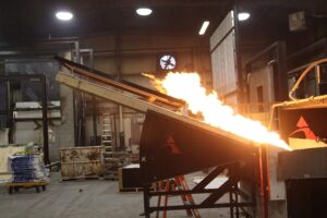 Flame in interior directed at material.