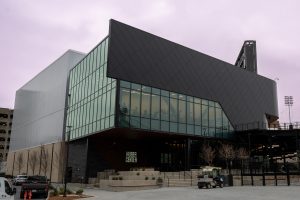 Black metal panels wrap around a distinctive geometric building.