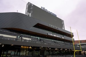 The "Huber Center" building name is presented in stark white over the black cladding of the structure.