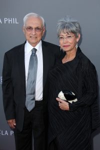 Two people posed in formal attire.