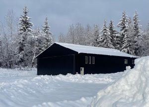 Snow-covered black metal structure.