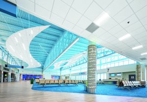 Bright airport interior with prominent blue and white materials.