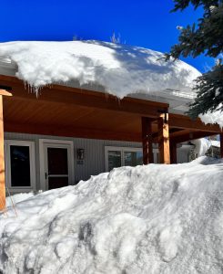 Snow piled thickly outside a residence.