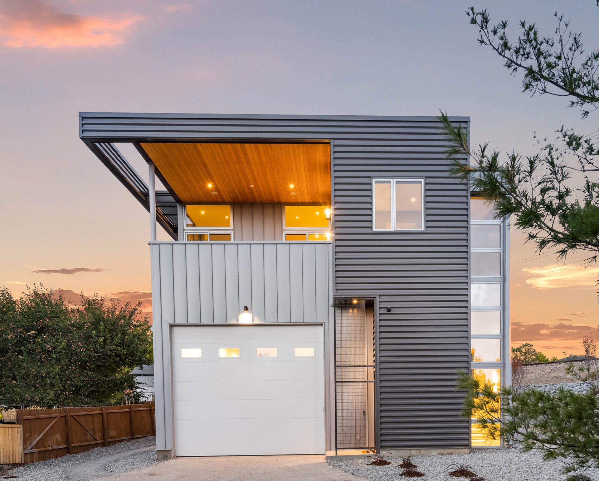 An example of Tomecek Studio Architecture's expressive designs, a modular metal-clad residence includes a large door.