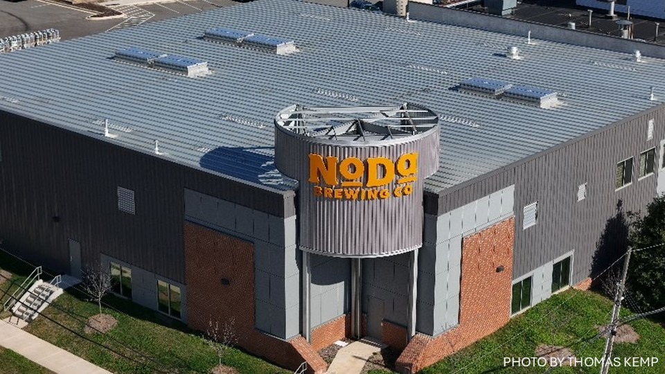 Silver colored cladding and roof on a rectangular building with smoke vents.