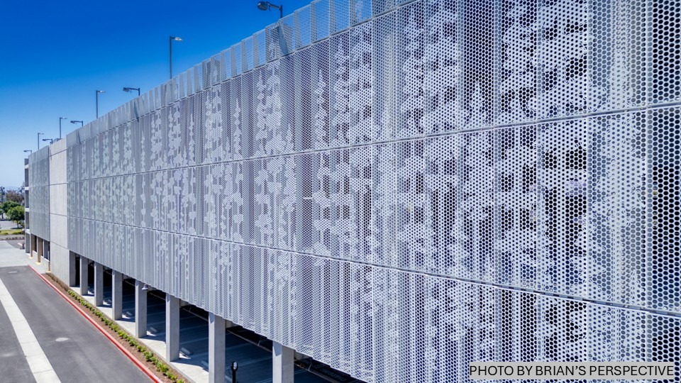 Perforated metal in natural patterns on a parking structure.