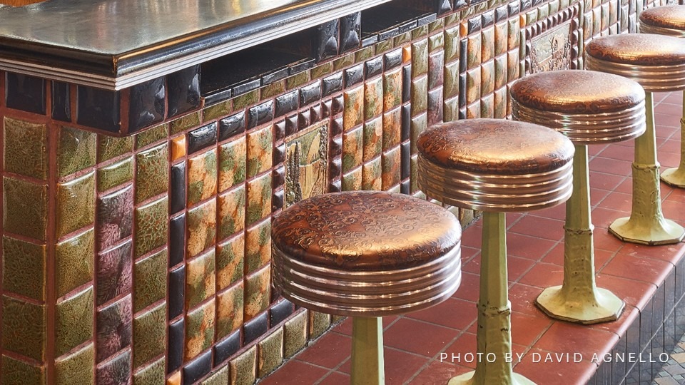 Copper-colored stools near bar interior