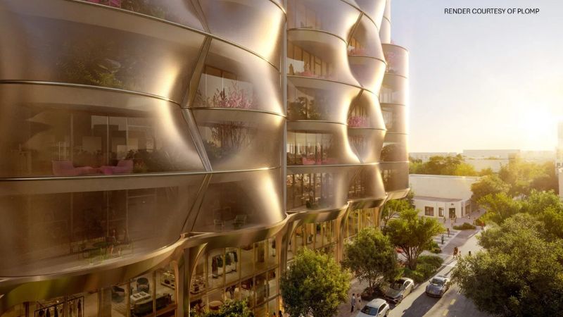 Architectural rendering of Snøhetta’s Miami tower, showing a curved champagne-metal facade, planted terraces, glazed ground-floor retail, and a landscaped street with pedestrians and cars.